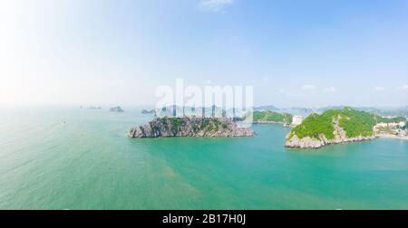 Aerial unique view Vietnam Cat Ba bay with floating fishing boats on sea, cloudscape tropical weather inspirational sunset, epic city skyline and skys Stock Photo