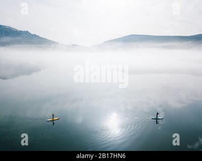 Aerial view of two people stand up paddle surfing, Leon, Spain