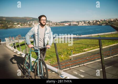 Young man commuting in the city with his fixie bike Stock Photo