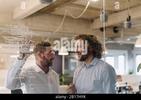 Two businessmen working on a project in office Stock Photo