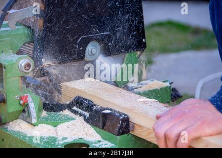 Man cutting wood using the circular saw Stock Photo