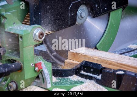 Man cutting wood using the circular saw Stock Photo