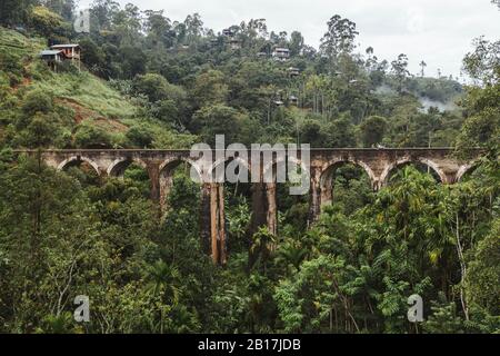 Sri Lanka, Uva Province, Demodara, Aerial view of Nine Arch Bridge across green forested valley Stock Photo