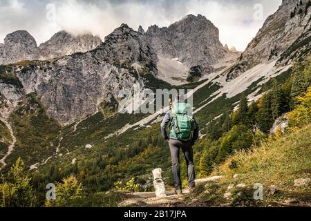 Woman on a hiking trip at Wilder Kaiser enjoying the view, Kaiser mountains, Tyrol, Austria Stock Photo