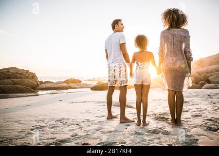 Family enjoying sunset at the beach