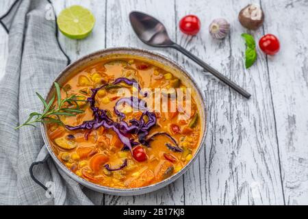 Bowl of potato curry on wooden table Stock Photo