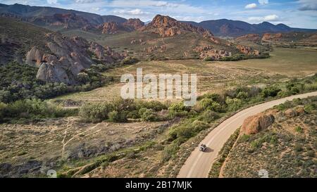 South Africa, Western Cape, Swellendam, Aerial view of 4x4 car driving along alpine dirt road Stock Photo