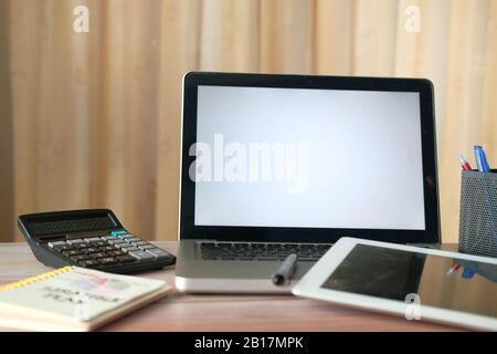 laptop, notepad and calculator on office desk  Stock Photo