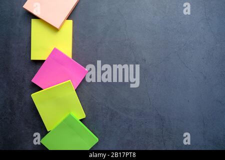 top view of colorful sticky notes on black table with copy space  Stock Photo