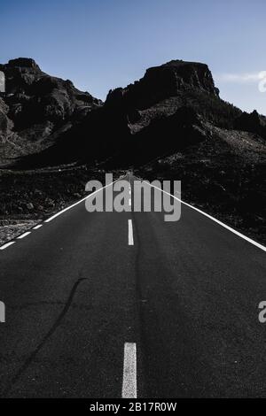 Long black asphalt road with infinity view - concept of travel and enjoy adventure - mountains scenic place - tenerife el teide national park Stock Photo