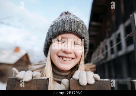 Portrait of happy girl wearing woolly hat in winter Stock Photo