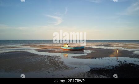 Mozambique Vilanculos, Aerial view of an old boat at the beach at low tight Stock Photo