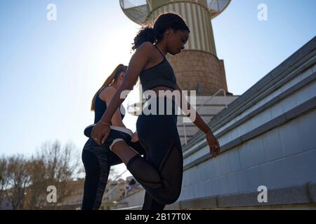 Two women exercising together outdoors Stock Photo