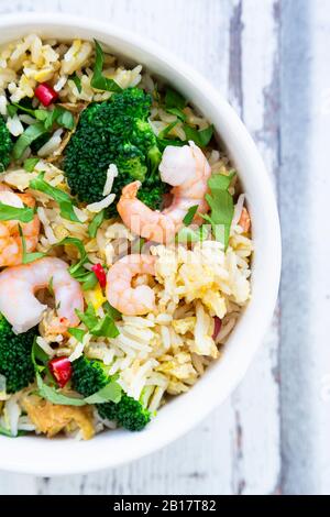 Fried basmati rice with broccoli and shrimp, chilli, coriander, lime, ginger Stock Photo