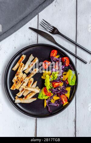 Turkey meat strips with vegetable salad Stock Photo