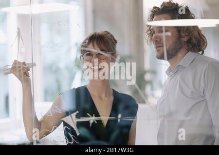 Businessman and businesswoman working on a project in office Stock Photo