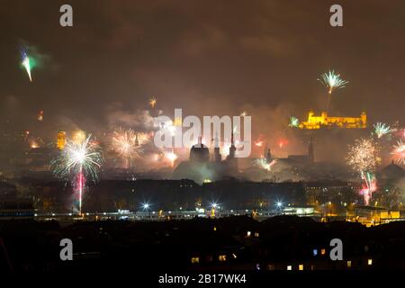 Germany, Wuerzburg, fireworks over cityscape at New Year's Eve Stock Photo