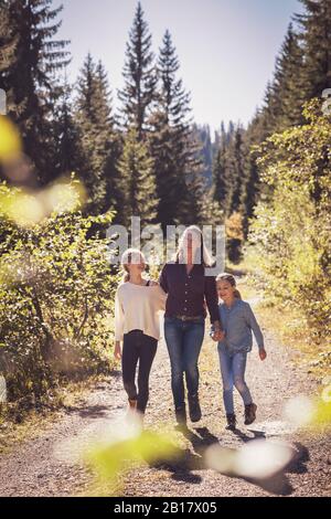 Mother hiking with daughters in the mountains Stock Photo