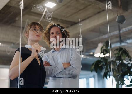 Businessman and businesswoman working on a project in office Stock Photo