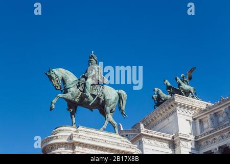 Italy, Rome, Low angle view of equestrian statue of Victor Emmanuel II against clear blue sky Stock Photo