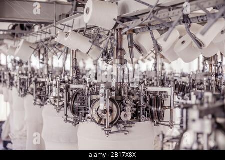 White cotton reels on a machine in a factory Stock Photo