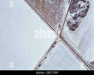 Russia, Moscow region, Aerial view of crossroad and snow covered fields Stock Photo