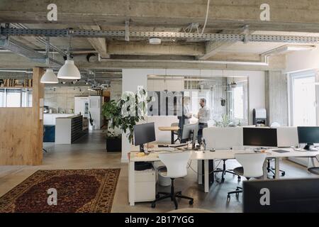 Two businessmen talking in office Stock Photo
