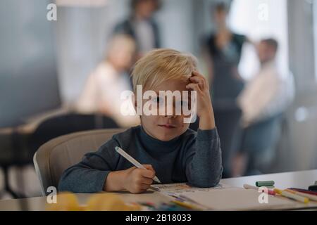 Portrait of boy painting in office Stock Photo