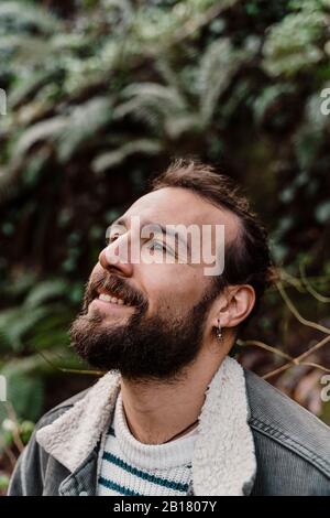 Smiling young man, looking up Stock Photo