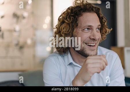 Portrait of happy businessman having a break in office Stock Photo