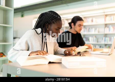 Two students learning in a library Stock Photo