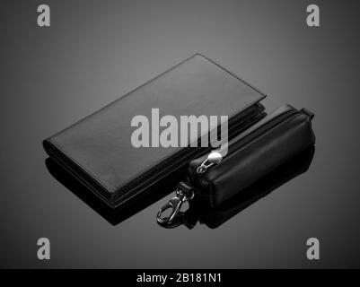 Fashionable leather men's wallet and key case on black background Stock Photo
