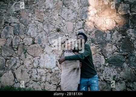 Laughing mother with teenage son outdoors Stock Photo