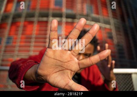 Palm of man raising his hand, Barcelona, Spain Stock Photo