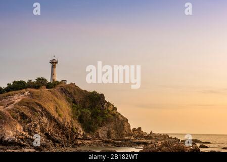 Light house at Lanta Krabi with water reflection and blue orange sky during sunset. Travel destination and nature environment concept. Stock Photo