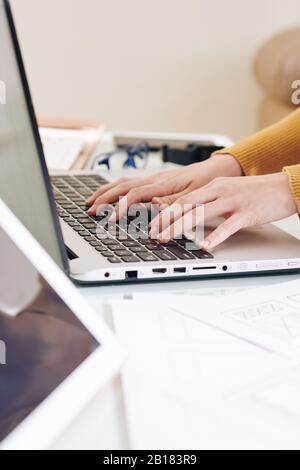 Hands of software developer working on laptop and creating programming code for new application of website Stock Photo