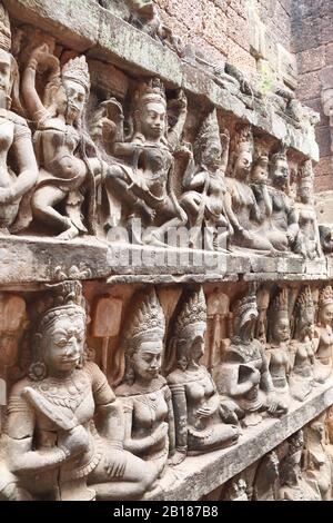Bas-relief on the Hidden Wall of Terrace of the Leper King. Carvings of Apsara dancers and guardians of underworld, Angkor Wat (Angkor Thom), Siem rea Stock Photo