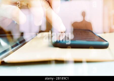 Hands with mobile, double exposure Stock Photo