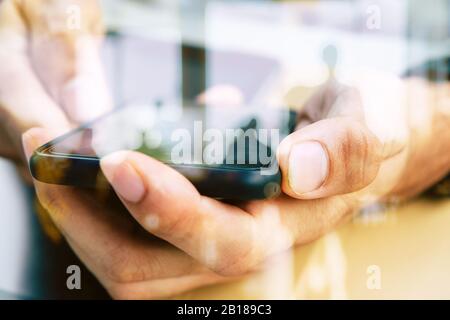 Hands with mobile, double exposure Stock Photo