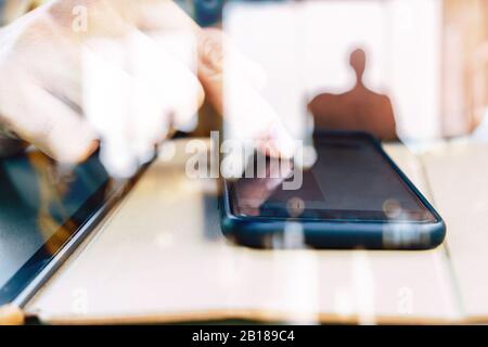 Hands with mobile, double exposure Stock Photo