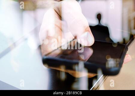 Hands with mobile, double exposure Stock Photo