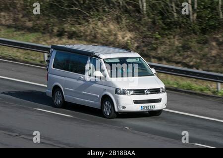 Volkswagen VW vee dub California Se Tdi Bmt White Diesel camper van driving on the M6 motorway near Preston in Lancashire, UK. Stock Photo