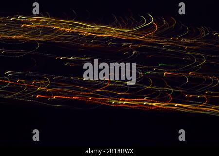 Colorful lines of light at night. Abstract background of night city lights. Abstract background. Abstract Motion Blur City. Night city lights. Abstract background of long explosure tale light on black Stock Photo