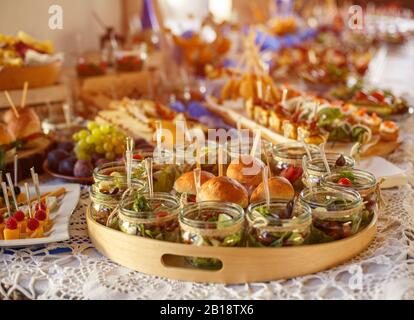 Beautifully decorated catering banquet table with different food snacks. Stock Photo