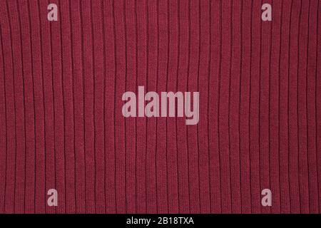 Texture of dark burgundy knitwear, Dark red knitted background Stock Photo