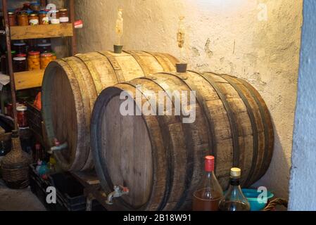 Wine barrels in a cellar with equipment for distillation of homemade wine Stock Photo