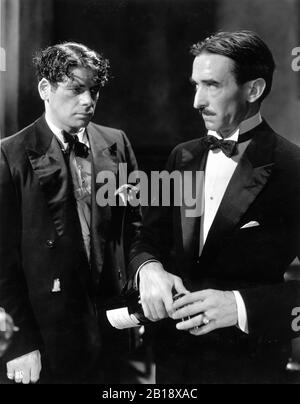 PAUL MUNI as Tony Camonte and OSGOOD PERKINS in SCARFACE 1932 directors HOWARD HAWKS and RICHARD ROSSON novel Armitage Trail screen story Ben Hecht producer Howard Hughes The Caddo Company / United Artists Stock Photo