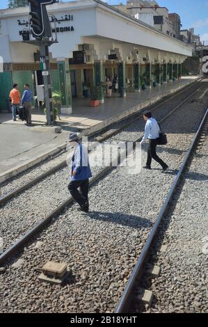 Railway passengers crossing the tracks, Morocco, North Africa Stock Photo