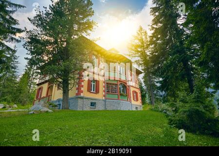 Cottage on the slope. Cottage village. Vacation Complex Hotel Building. Hotel in forest. Stock Photo