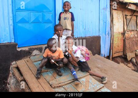 Kibera, Nairobi, Kenya - February 13, 2015: A group of poor children at a burnout hut in slums Stock Photo